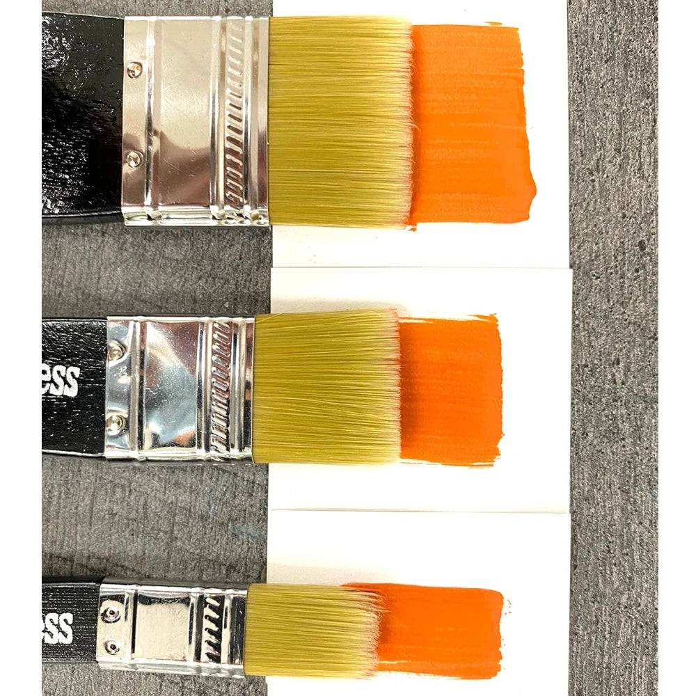 Three paintbrushes with orange and yellow bristles on a white card against a gray background.