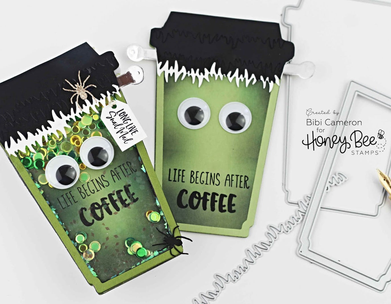 Two green coffee cup-shaped cards with googly eyes and text, featuring a spider and spider web design, on a white background.
