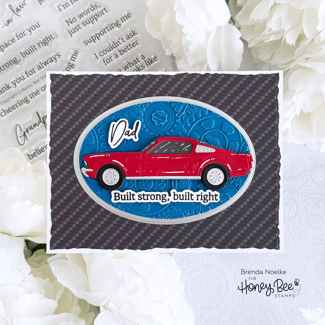Card with red car illustration and text on a carbon fiber pattern background, surrounded by white flowers.