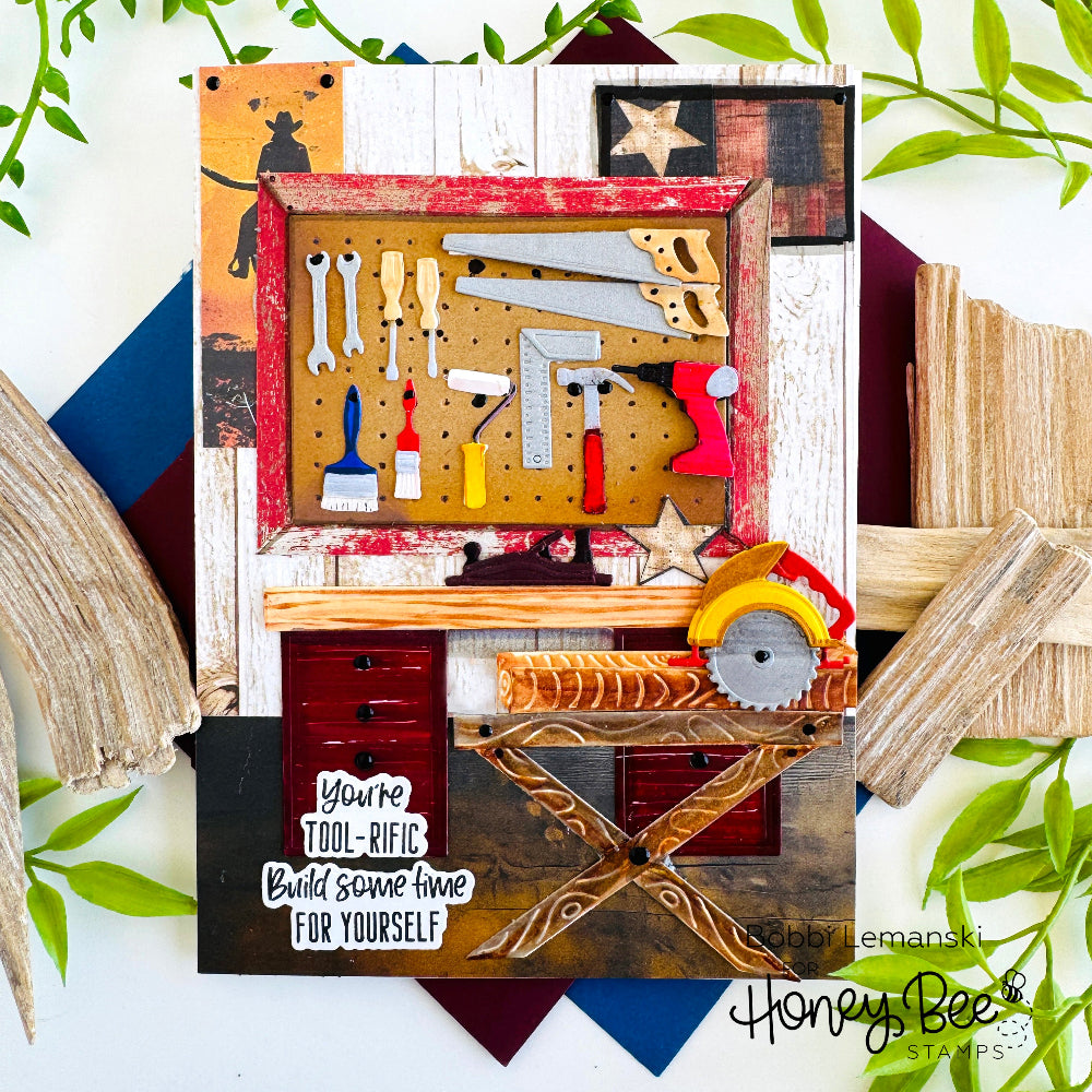 Decorative wall art with tools and a quote, featuring the brand 'Honey Bee Stamps'.
