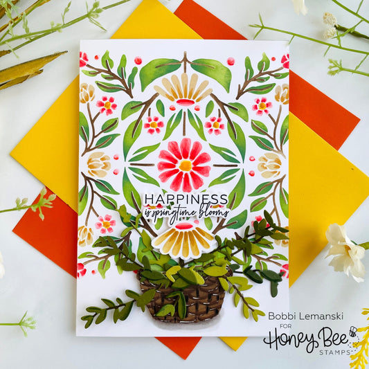 Handmade card featuring a floral stencil design with the text 'HAPPINESS is springtime blooms'