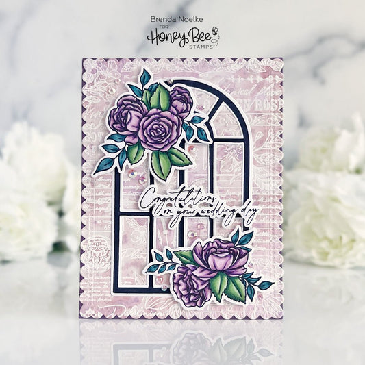 Handmade wedding card featuring purple floral arrangements and an arched window design.