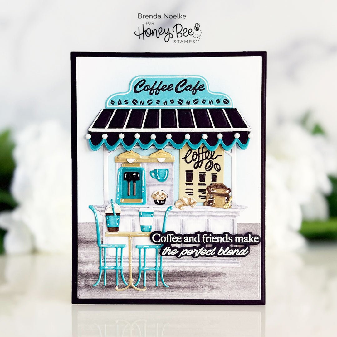 Handmade card featuring a 3D coffee cafe scene with the quote 'Coffee and friends make the perfect blend'.