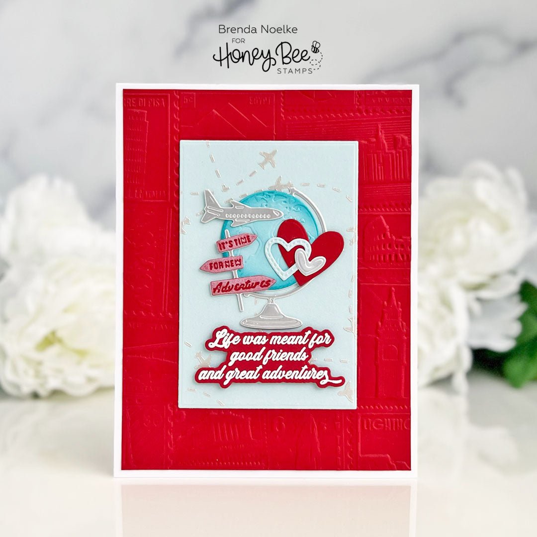 Handmade red greeting card featuring a globe, airplane, hearts, and travel-themed sentiment.