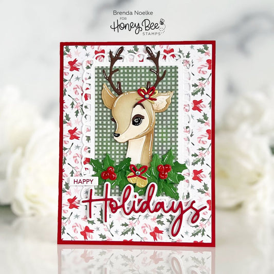 Handmade holiday card featuring a cute deer illustration with holly and 'Happy Holidays' text.