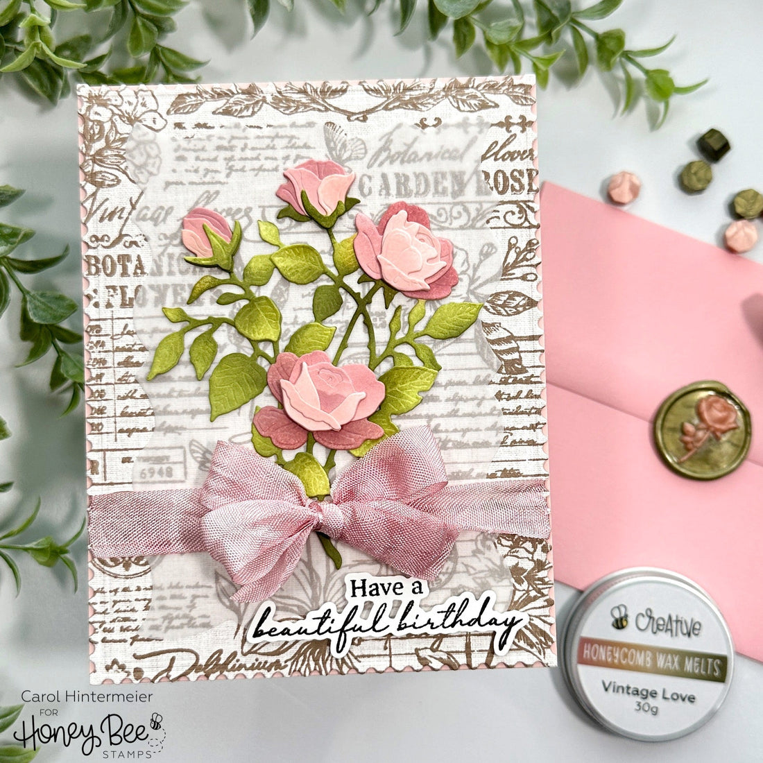 Handmade birthday card with 3D pink paper roses, a pink ribbon bow, and vintage script background.
