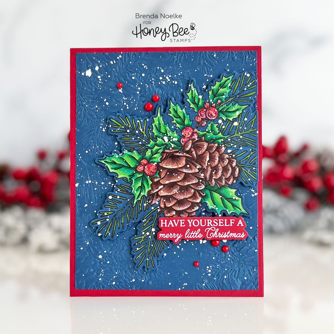 Handmade Christmas card with a pinecone, holly, and 'Have Yourself a Merry Little Christmas' text.