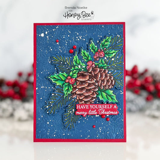 Handmade Christmas card with a pinecone, holly, and 'Have Yourself a Merry Little Christmas' text.