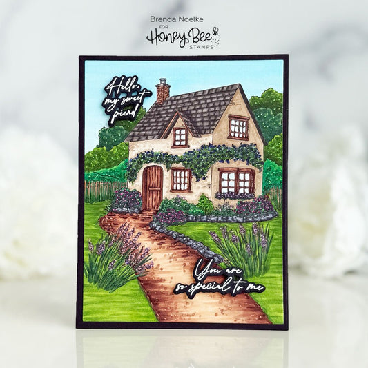 Handmade card featuring a colorful illustrated English cottage with a winding garden path.