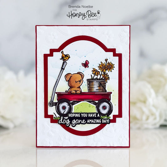 Handmade card featuring a brown puppy in a red wagon with flowers and a bird.