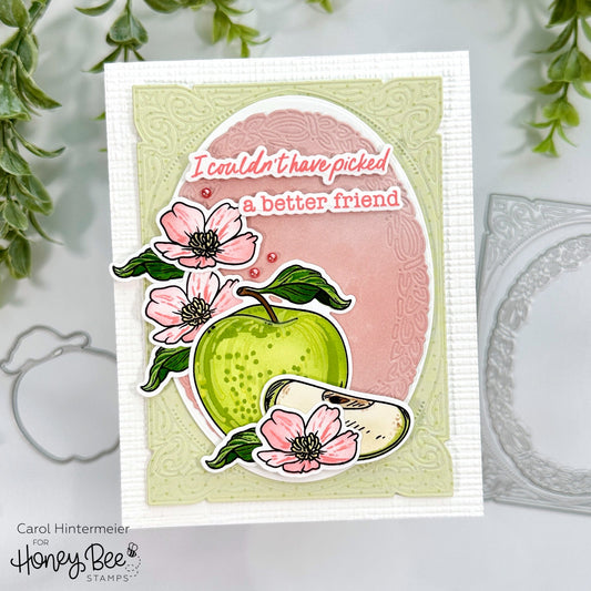 Handmade card with a green apple, pink flowers, and 'I couldn't have picked a better friend' text.
