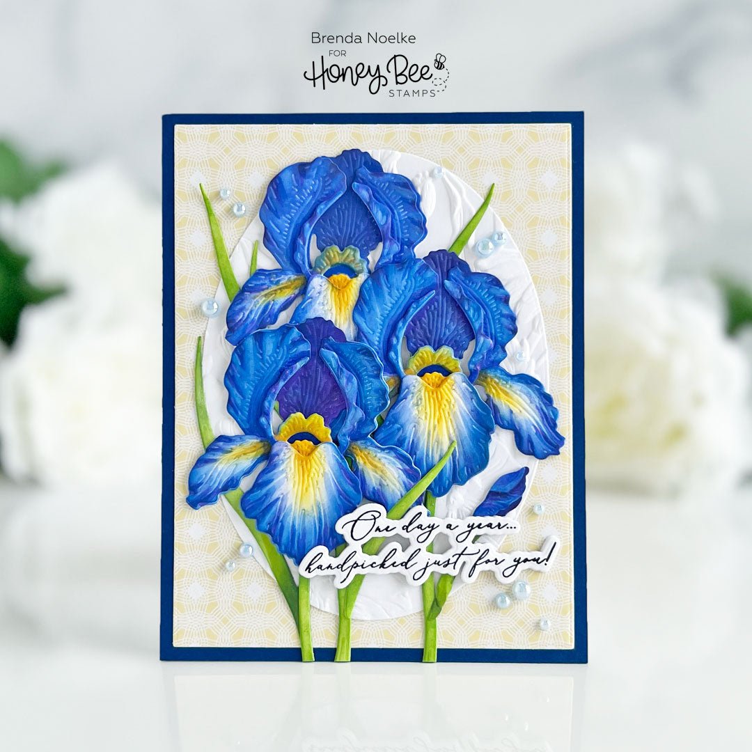 Handmade birthday card featuring blue iris floral stamps and a sentiment label.