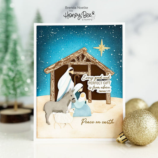 Handmade Christmas card featuring a layered Nativity scene with a stable and starry night sky.