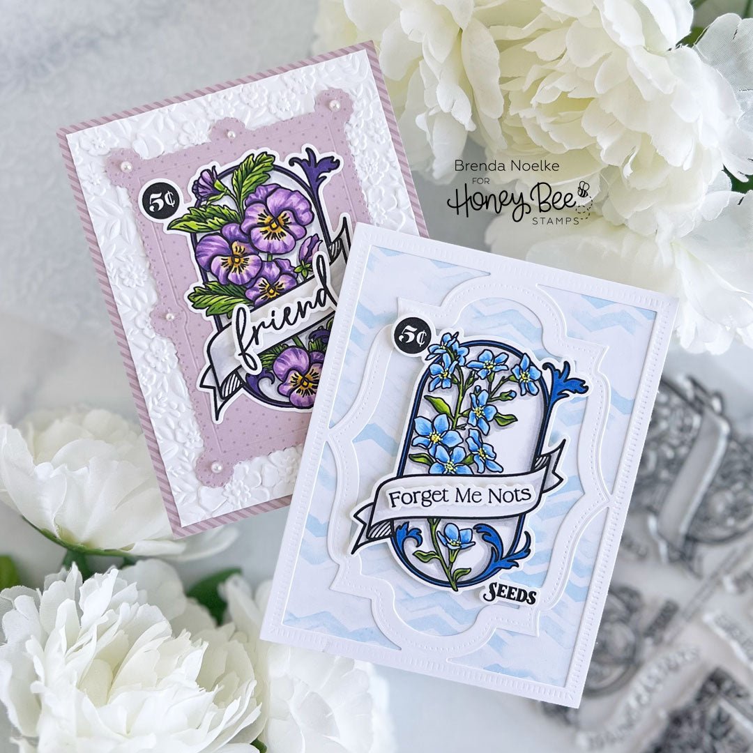 Two handmade Spring Seeds cards with purple pansies and blue forget-me-nots.