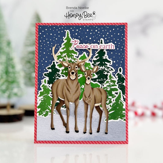Handmade card with two deer in a snowy forest and 'Peace on Earth' text.