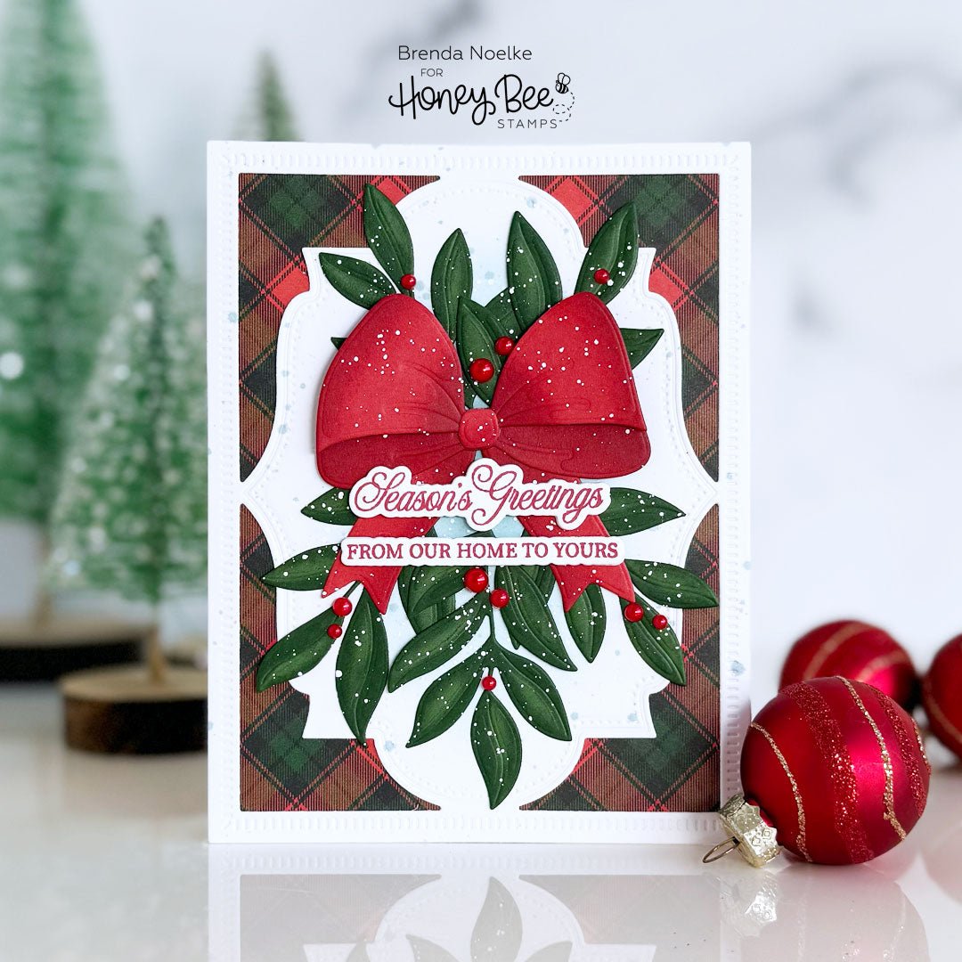 Handmade Christmas card with a red bow, green leaves, and 'Season's Greetings' text.