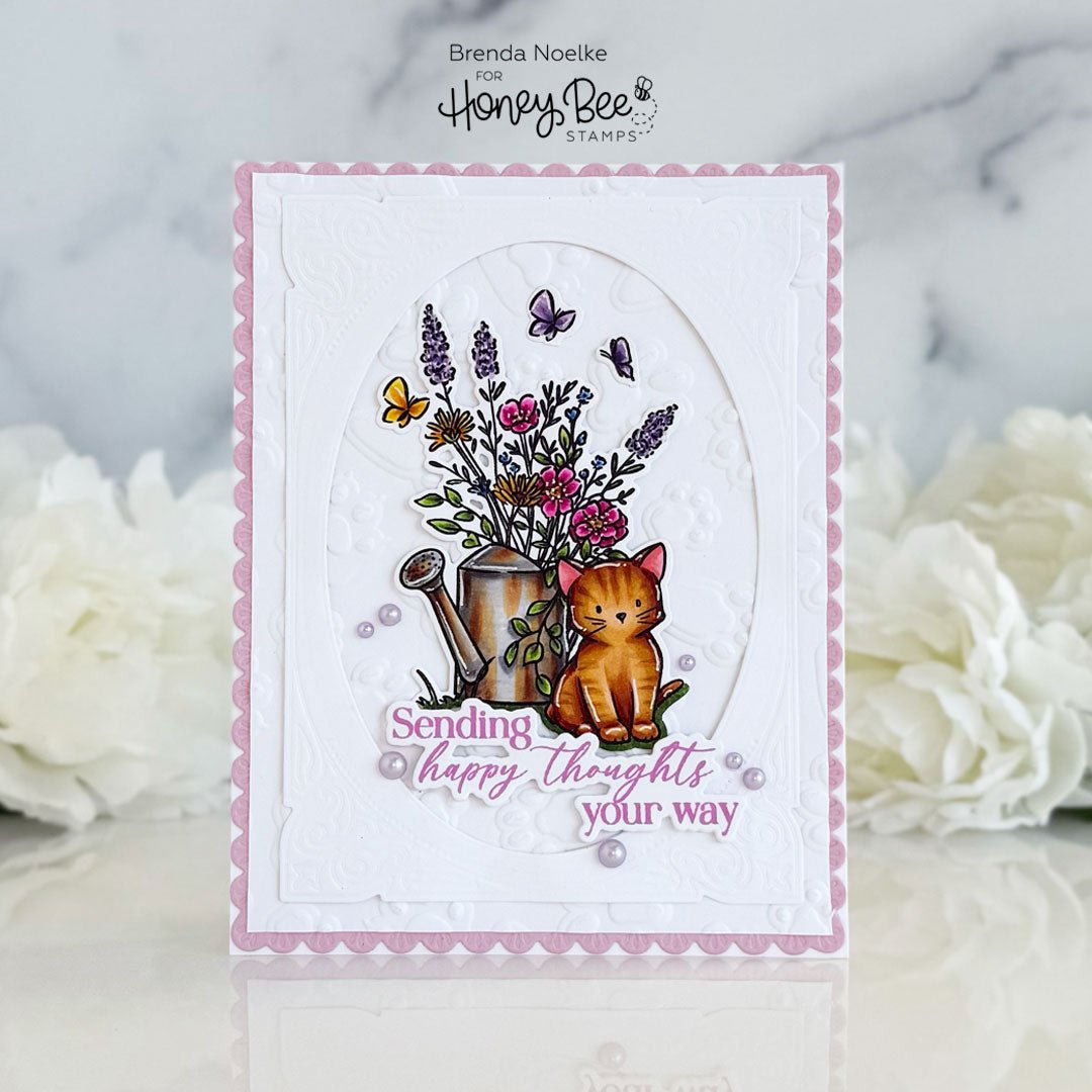 Handmade card featuring an orange cat next to a watering can of flowers and 'Sending happy thoughts your way' text.