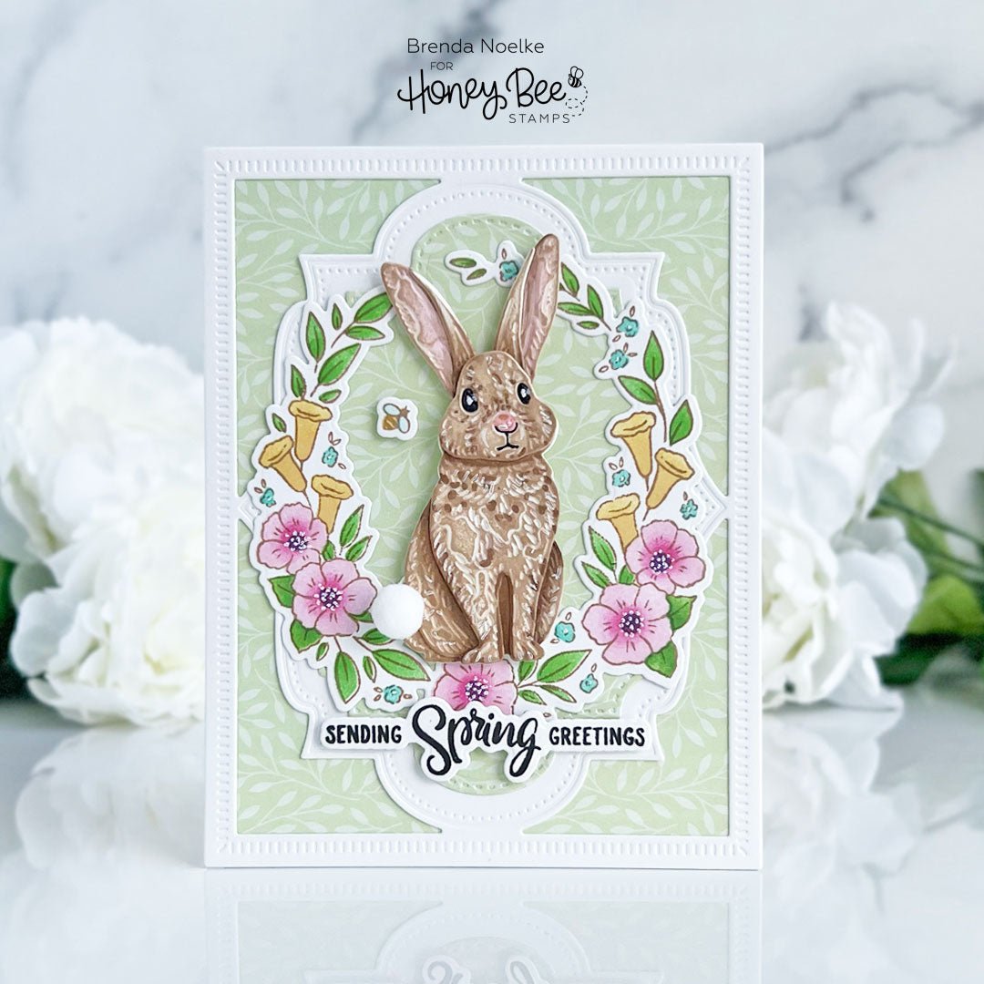 Handmade spring greeting card featuring a brown rabbit, pink flowers, and 'Sending Spring Greetings' text.
