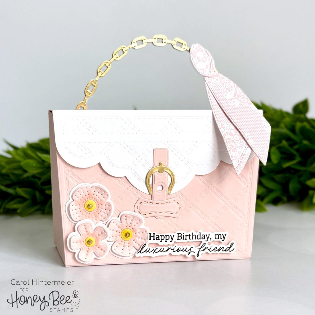 Handmade pink purse-shaped birthday card with floral embellishments and a gold chain handle.