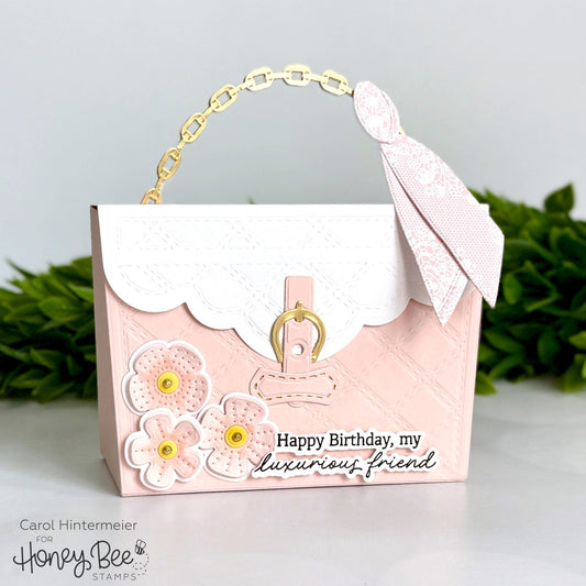 Handmade pink purse-shaped birthday card with floral embellishments and a gold chain handle.
