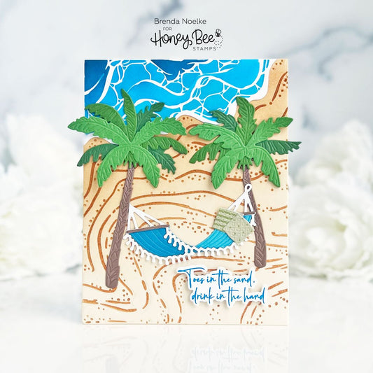 Handmade beach-themed card featuring palm trees, a blue hammock, and sandy beach layers.