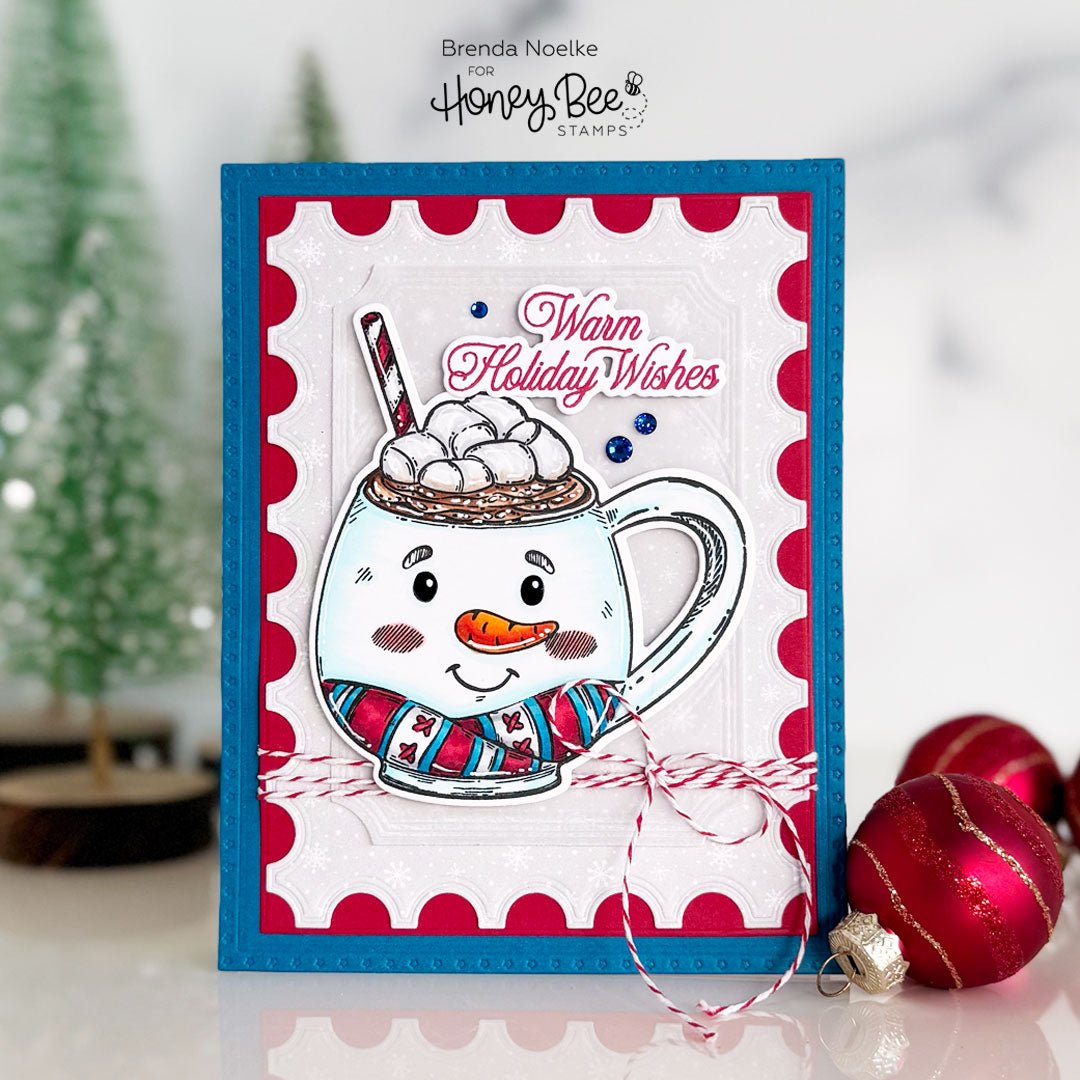 Handmade holiday card featuring a cute snowman hot cocoa mug with 'Warm Holiday Wishes' text.