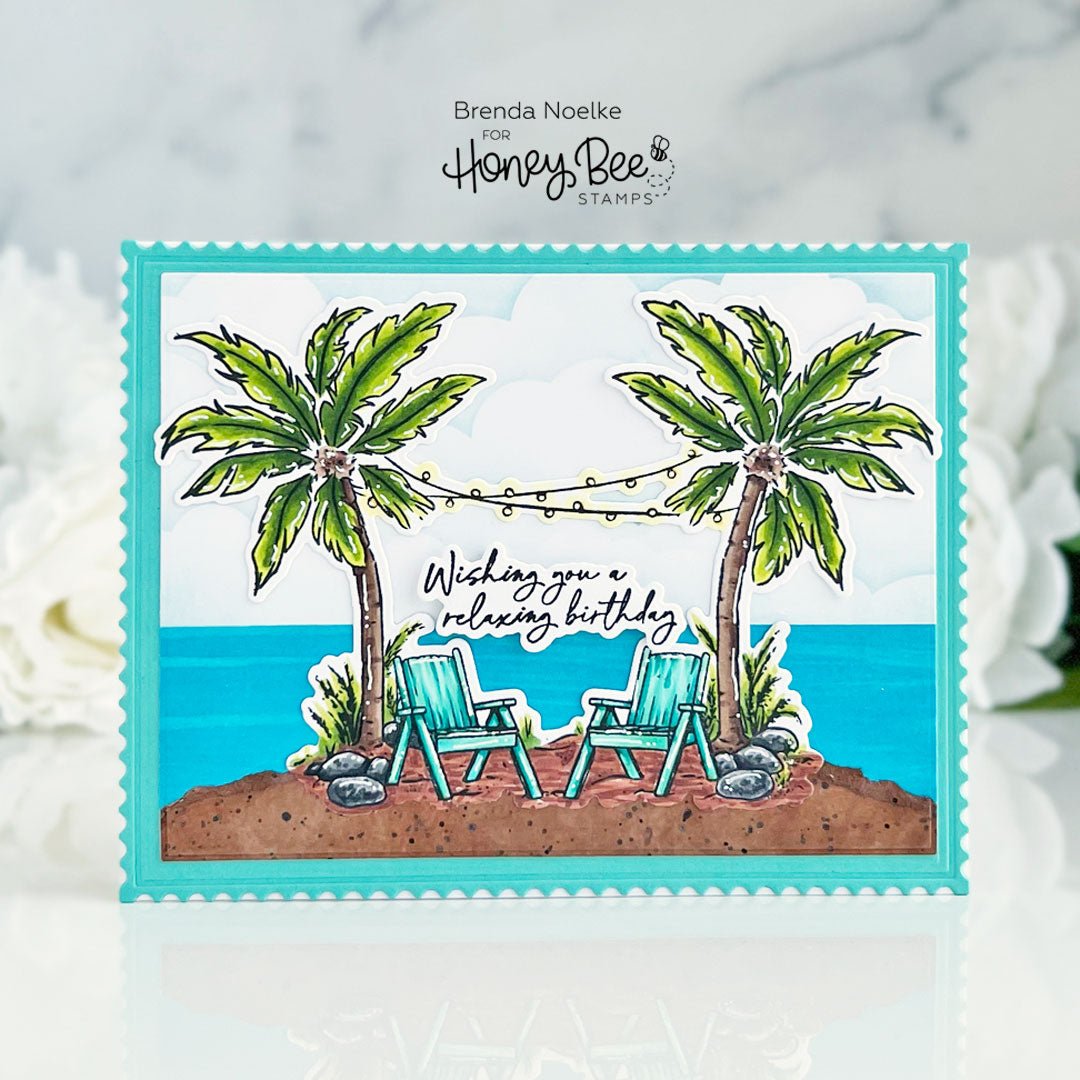 Handmade birthday card featuring a beach scene with palm trees and two lounge chairs.