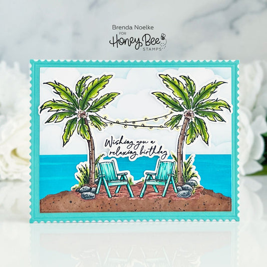 Handmade birthday card featuring a beach scene with palm trees and two lounge chairs.