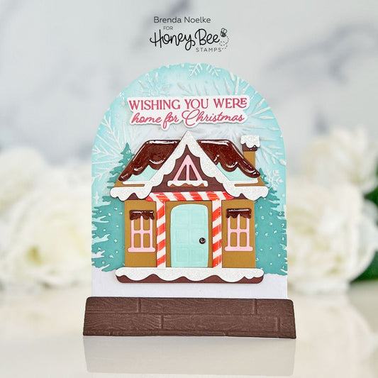 Snow globe shaped Christmas card featuring a gingerbread house and festive greeting.