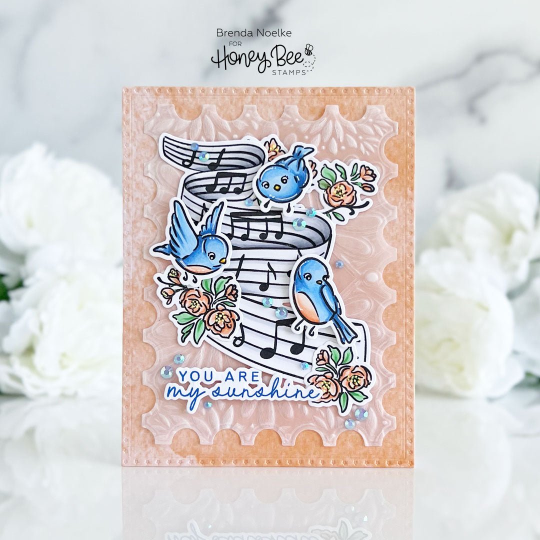 Handmade card with blue birds, musical notes, and flowers reading 'You are my sunshine'.