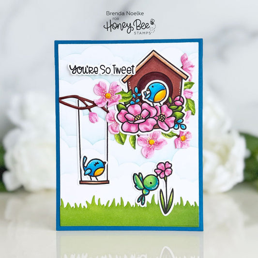 Handmade card with 'You're So Tweet' text, blue birds, a birdhouse, and pink flowers.