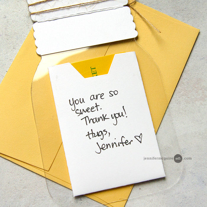 White card with a handwritten message on a yellow envelope