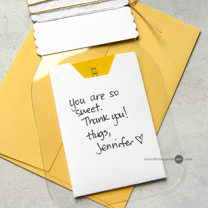 White card with a handwritten message on a yellow envelope