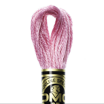 Ball of pink embroidery floss with DMC label on a white background