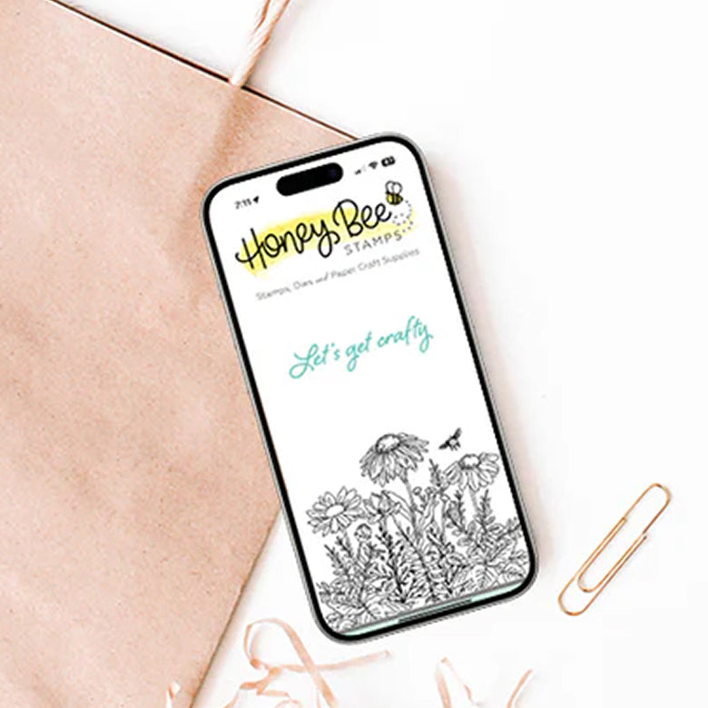 Phone displaying Honey Bee Stamps app with floral design on a light background