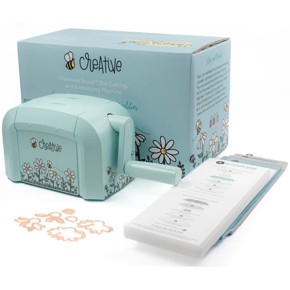 A mint green Creative Platinum Scout die cutting and embossing machine shown with its matching blue packaging box, instruction booklet, and sample cutout pieces on a white background.