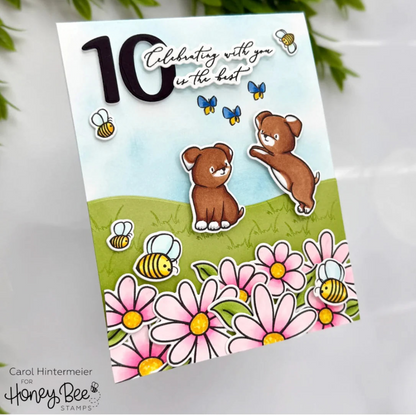 Greeting card with two brown bears, flowers, and bees on a white background