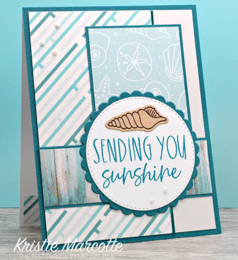 Card with 'Sending you sunshine' text and a shell design on a blue background