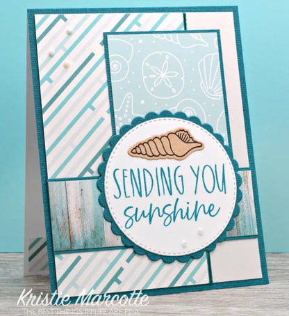 Card with 'Sending you sunshine' text and a shell design on a blue background