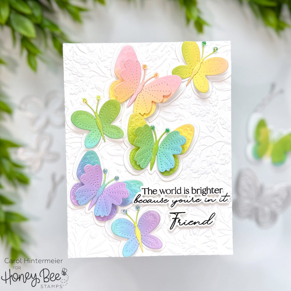 Card with colorful butterflies and text 'The world is brighter because you're in it, Friend' on a white background.