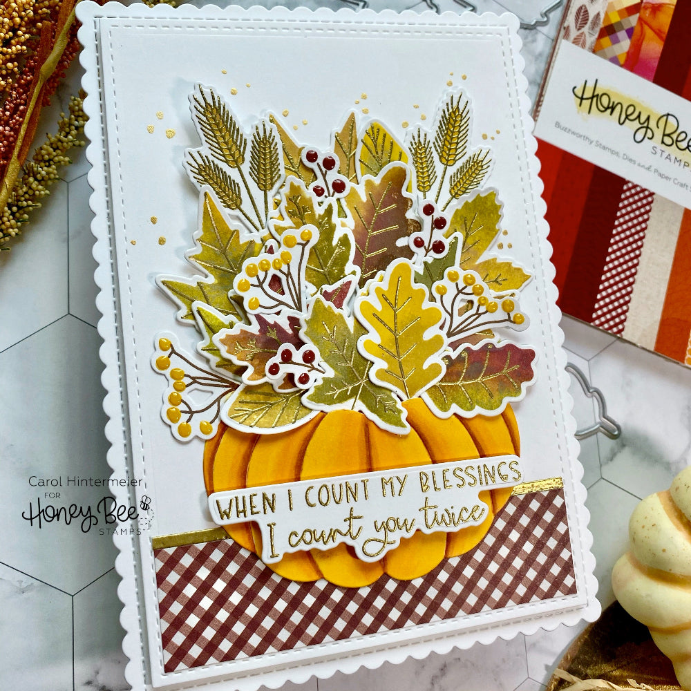 Autumn-themed card with pumpkins and leaves on a checkered background, featuring the brand 'Honey Bee'.