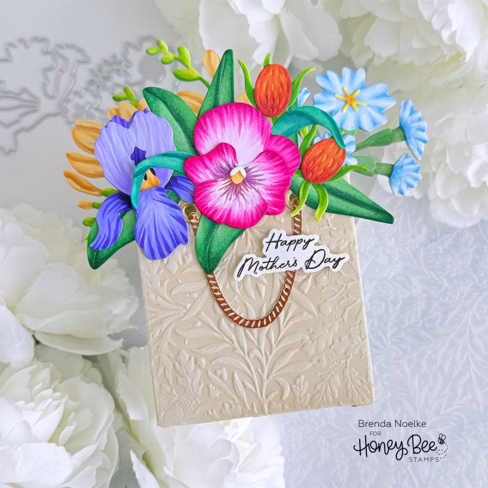 Colorful floral arrangement on a card with 'Happy Mother's Day' text, surrounded by white flowers.