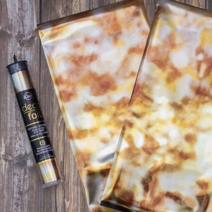 Decorative foil with pizza design and a canister labeled 'decor foil' on a wooden surface.