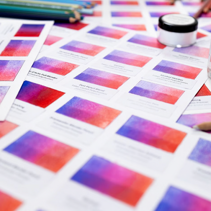 Color swatches and paint samples on a table with a focus on color mixing.