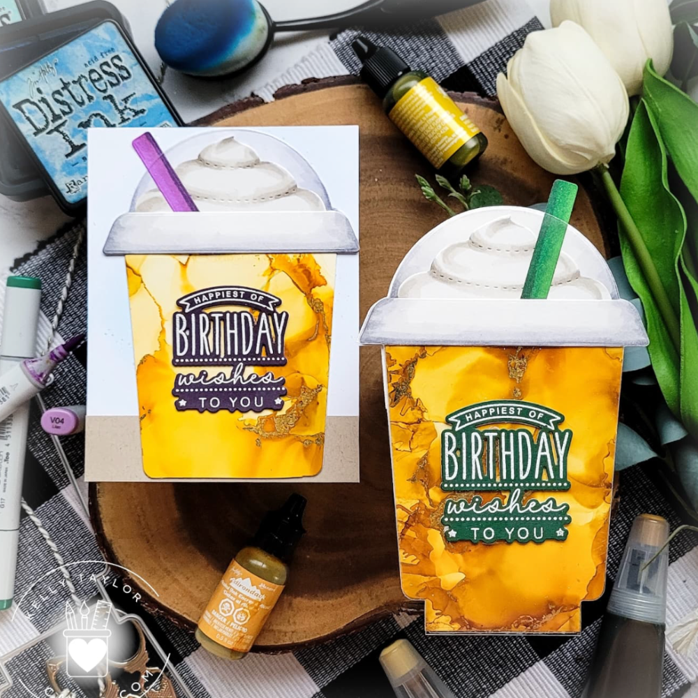 Two 'Happy Birthday' themed drinks with a checkered tablecloth and stationery items.