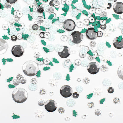 Assorted decorative elements including silver hexagons, green trees, and white flowers on a white background