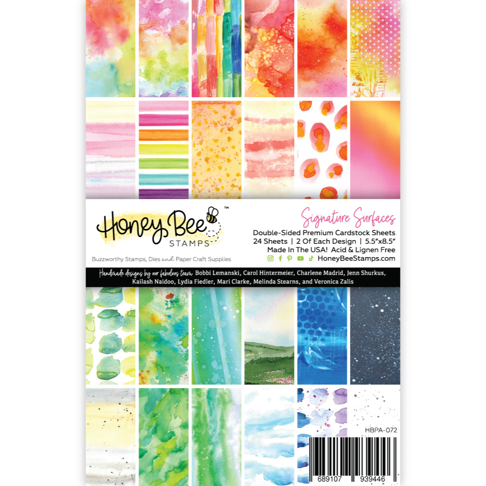 Honey Bee Stamps cardstock sheets with colorful watercolor designs on a white background