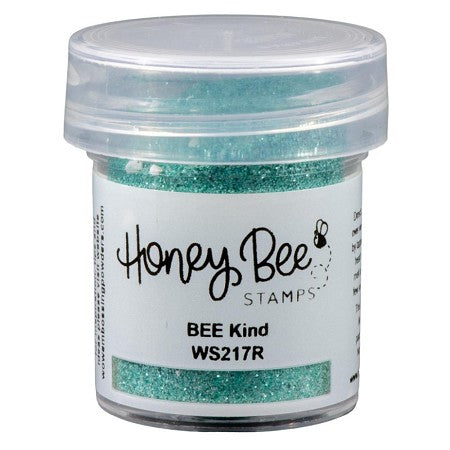 Jar of turquoise glitter with 'Honey Bee Stamps' label on a white background