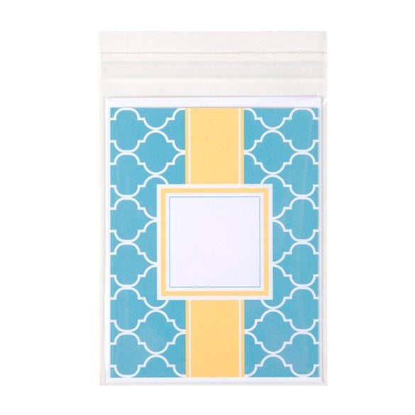 Notebook with blue geometric pattern and yellow square on a white background
