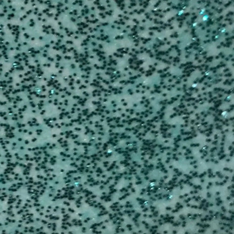 Textured surface with black specks on a light blue background